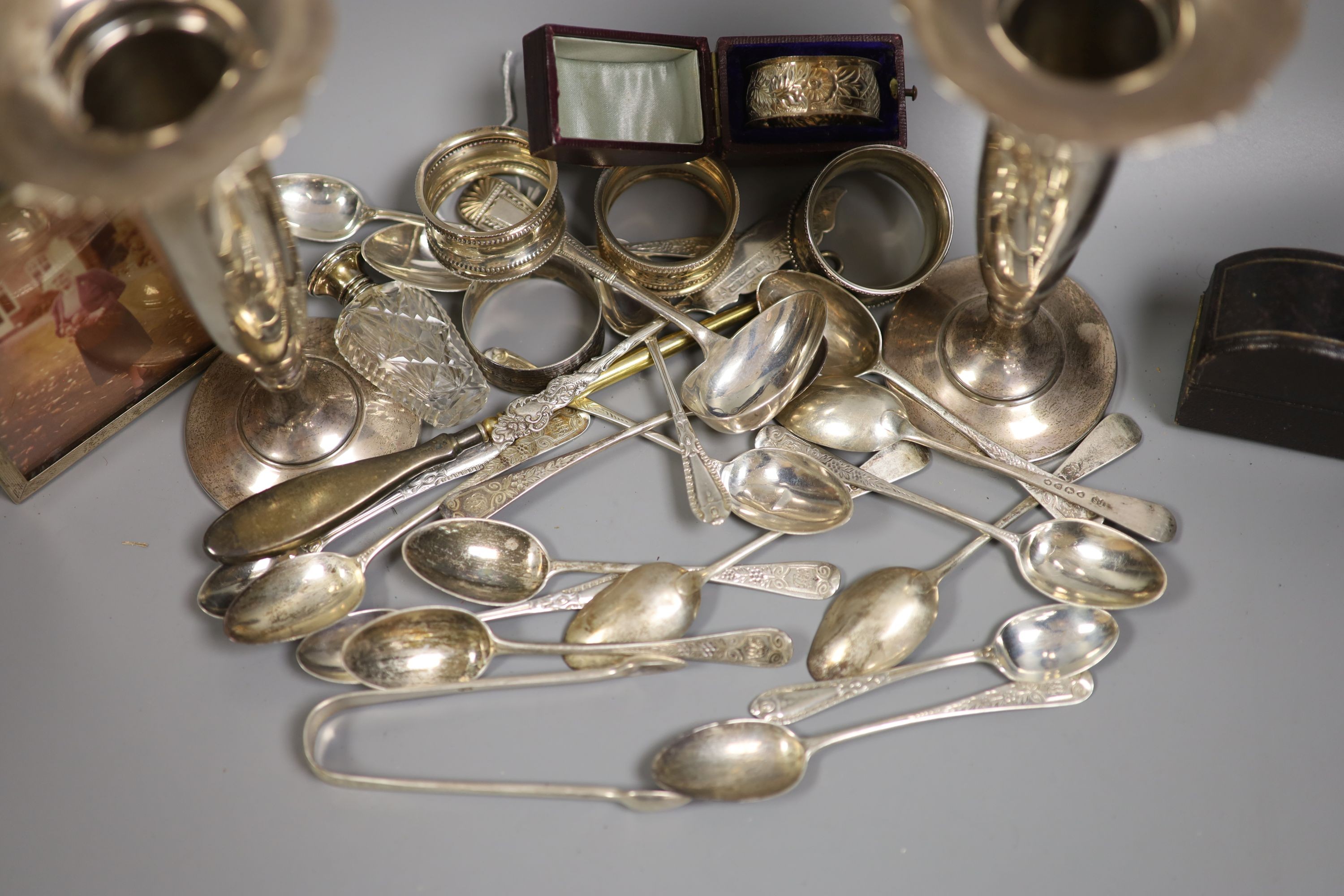 Sundry silver including a pair of spill vases, napkin rings, teaspoons sent bottle etc.